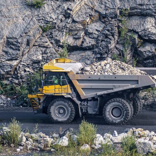 Dump truck in limestone mining, heavy machinery. Mining in the quarry.